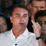 What are the investigations into Flávio Bolsonaro, the defeated presidential candidate who fled Brazil for the US?